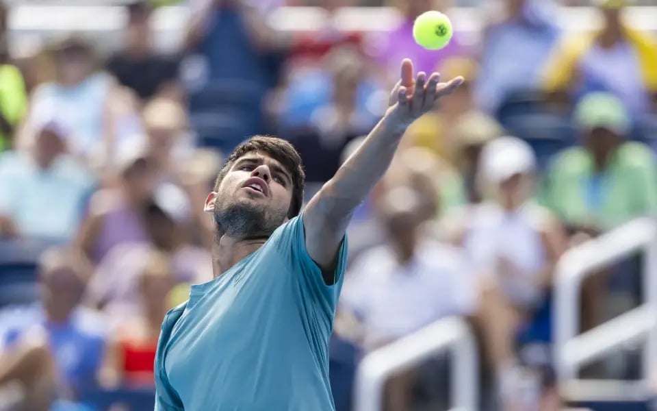 Carlos Alcaraz plays a ball against opponent Hamad Medjevic