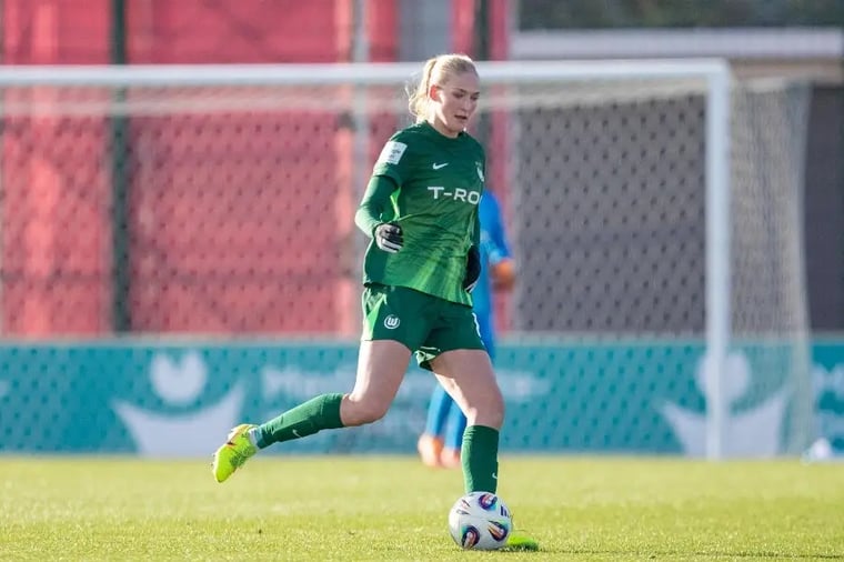 female-soccer-player-dribbling-ball-field