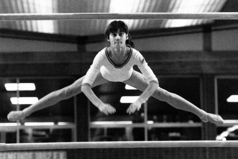 gymnastics-woman-performing-splits-bars