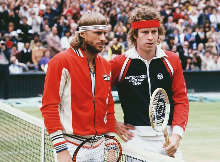 Bjorn Borg and John McEnroe at the net.