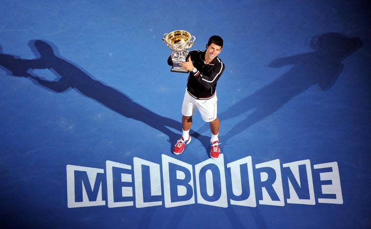 Novak Djokovic of Serbia poses with his trophy after winning the men s singles final at 2012 Australian Open tennis tournament in Melbourne.