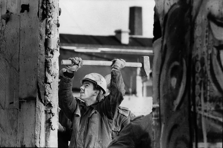 Mann mit Hammer Abriss der Berliner Mauer 1990