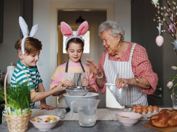grandma and grand children cooking for easter image