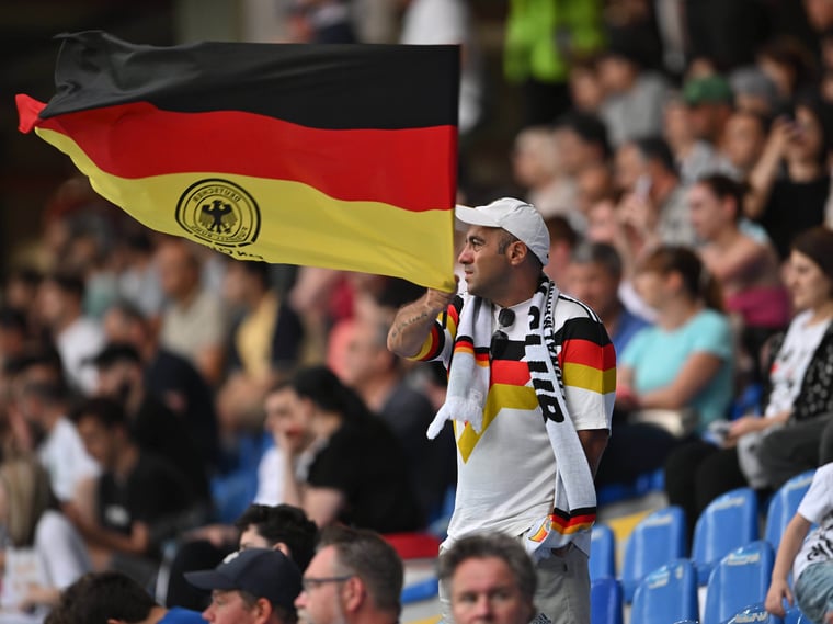 A Germany fan waves a flag during the UEFA