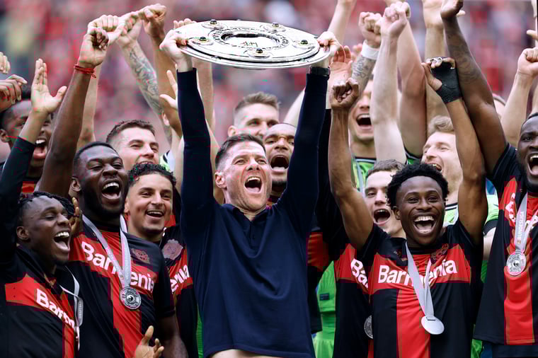 Photo of Xabi Alonso celebrating winning the Bundesliga together with his team.