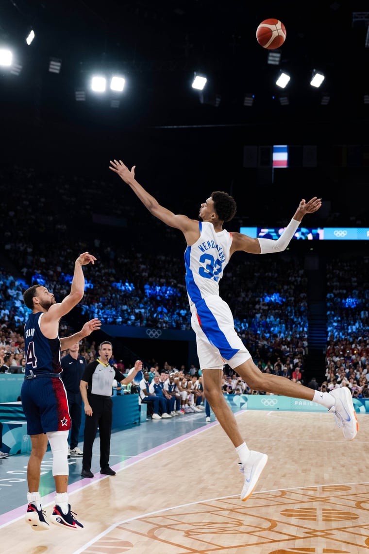 Stephen Curry shooting over Victor Wembanyama Paris 2024 basketball