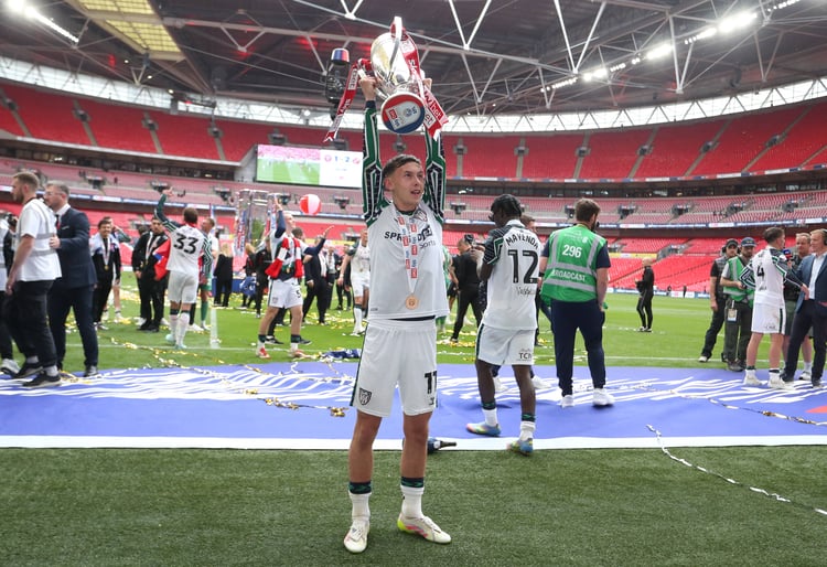 Photo of Chris Rigg lifting Championsship Trophy