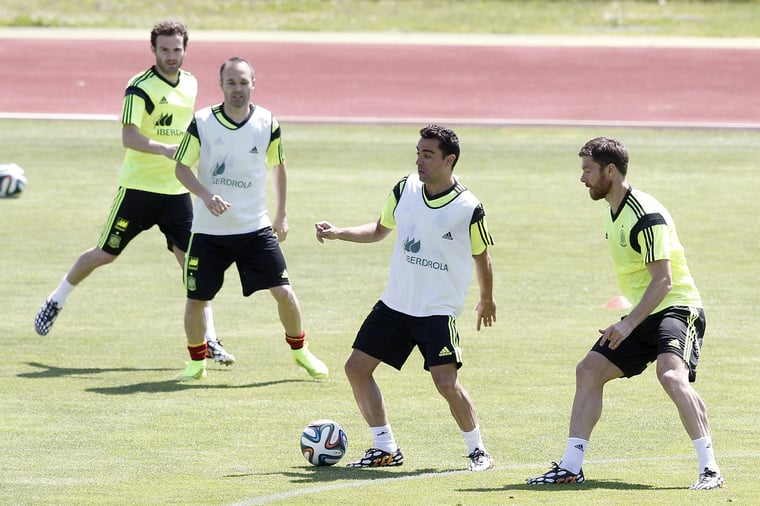 Photo of Xabi Alonso, Xavi Hernandez, Andres Iniesta and Juan Mata during a training session for Spain's national team in 2014.