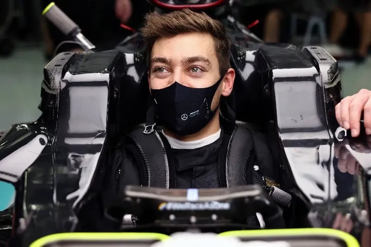 race-car-driver-in-cockpit-wearing-mask