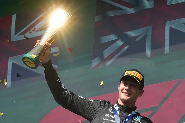 race-winner-holding-trophy-podium-celebration