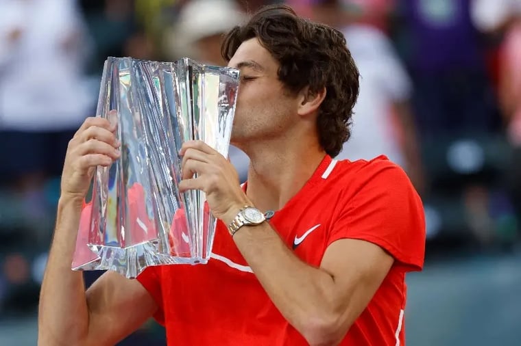 tennis-player-kissing-trophy-victory-celebration (1)