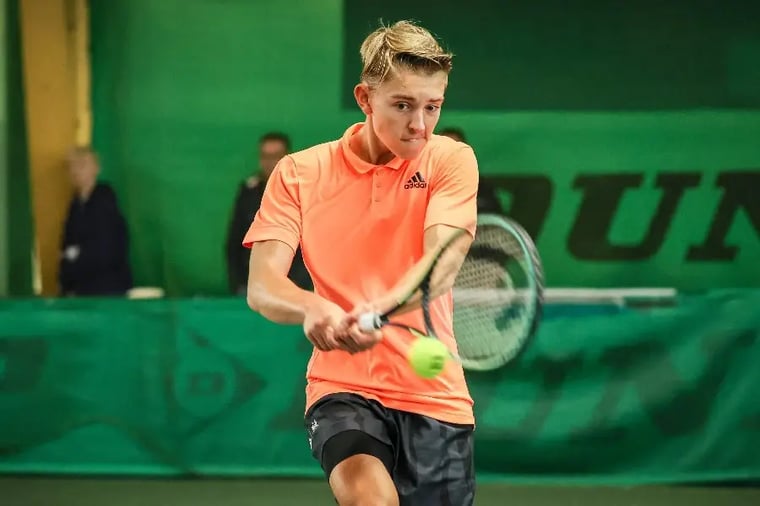 young-male-tennis-player-hitting-backhand