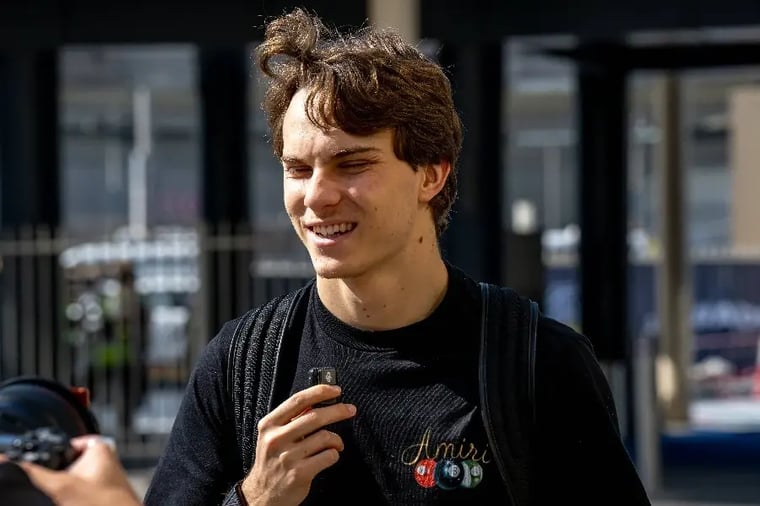 young-man-smiling-outdoors-casual-attire